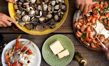 portugal seafood on table with people using utencils