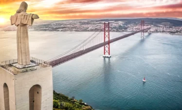 portugal statue overlooking bridge
